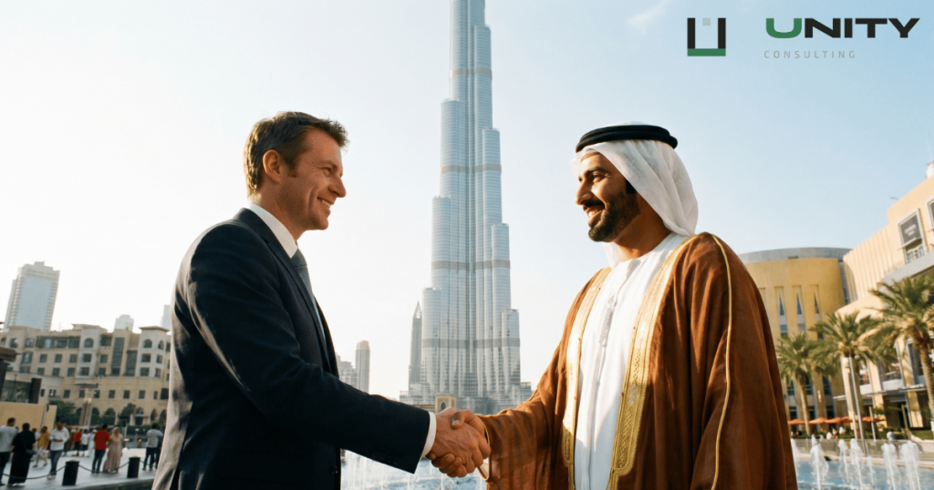 Western founder and Emirati partner shaking hands before the Burj Khalifa — establishing a 0% tax UAE free zone company