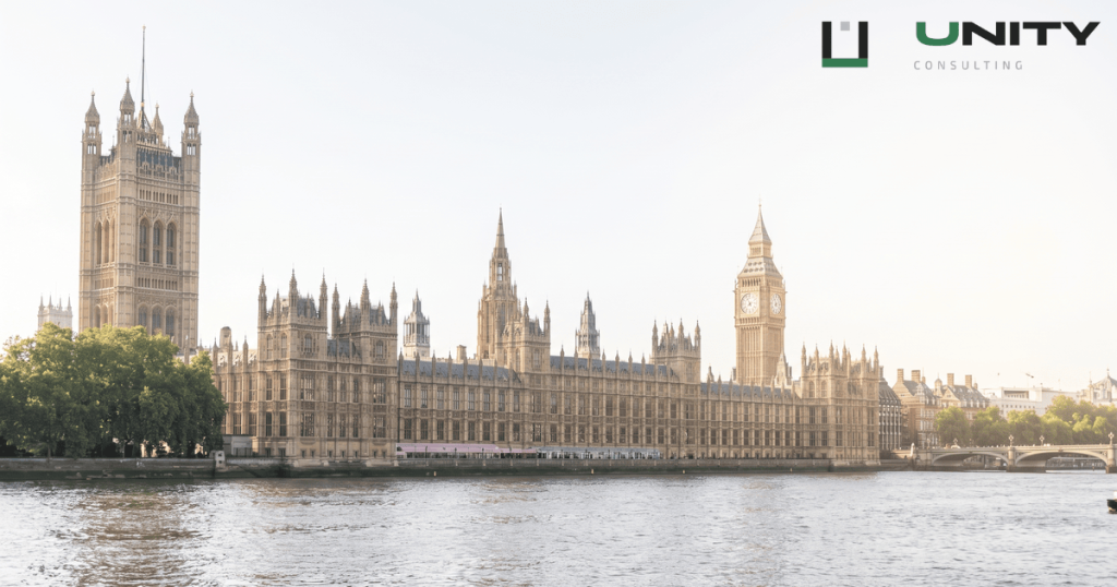 A wide-angle shot of the Houses of Parliament and Big Ben across the River Thames on a bright, clear day in London.