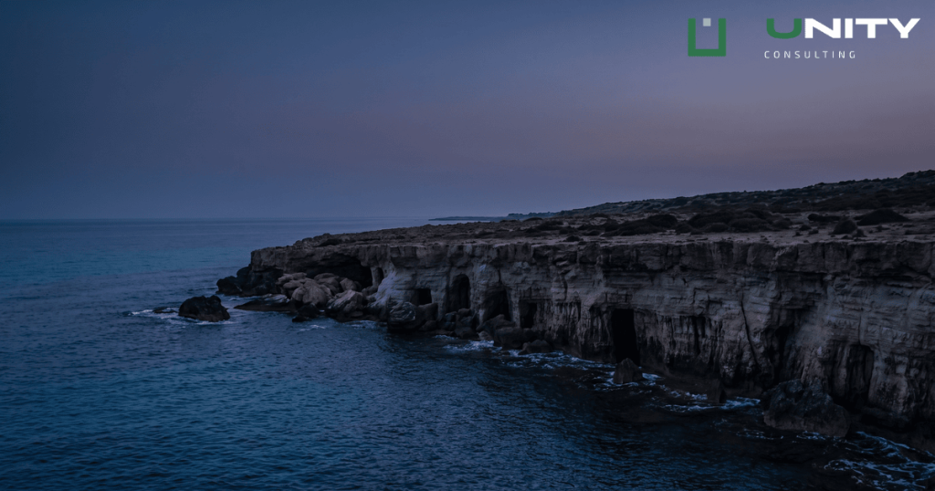 A twilight view of dramatic cliffs plunging into the dark blue Mediterranean Sea at Cape Greco, Ayia Napa.
