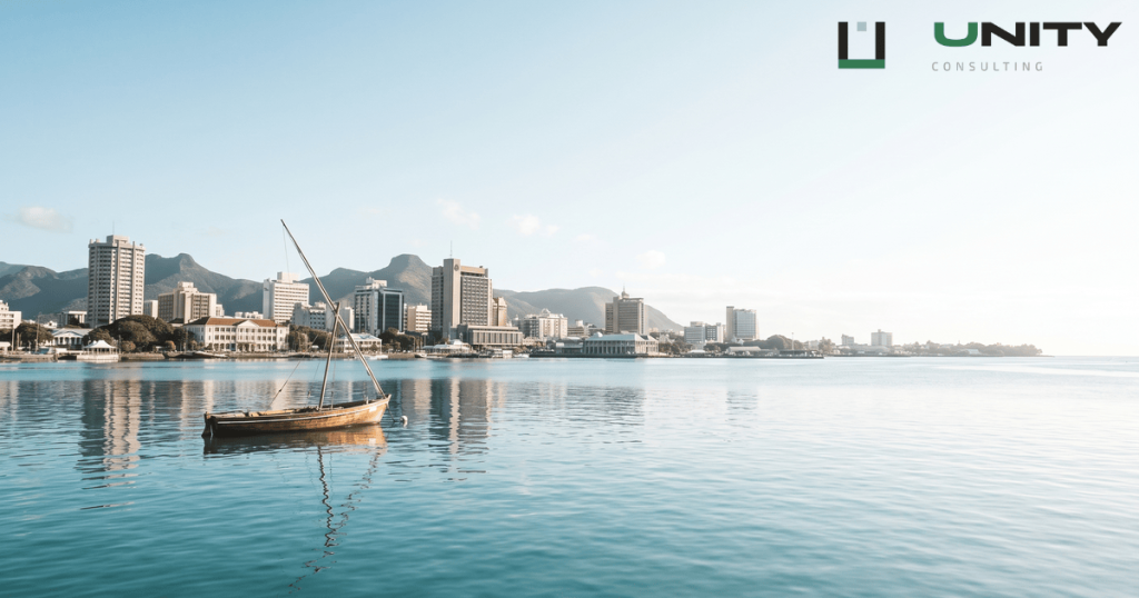 Panoramic view of Port Louis harbour and city skyline in Mauritius under a bright, clear morning sky.